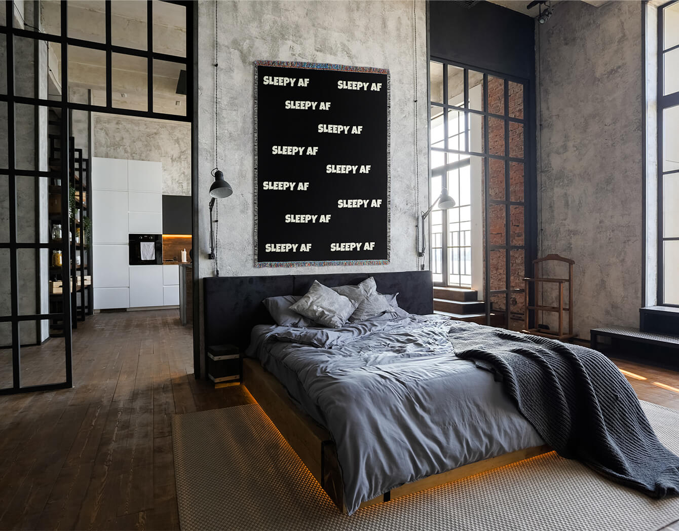 Modern bedroom with a bed, wall art, and large windows.