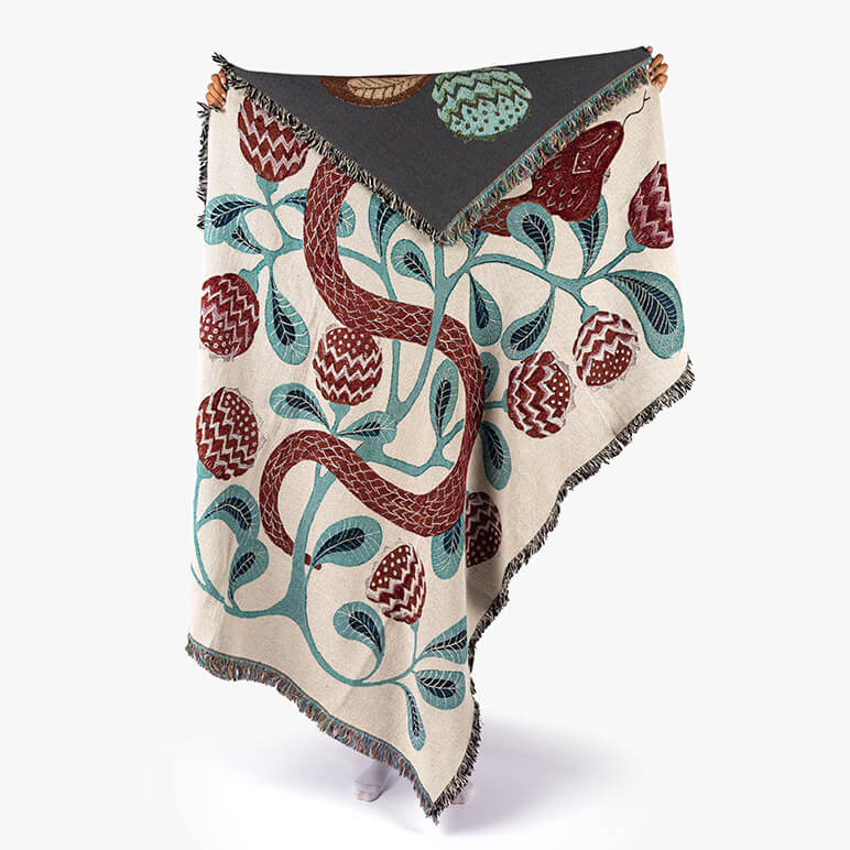 Decorative throw blanket with snake pattern on a white background