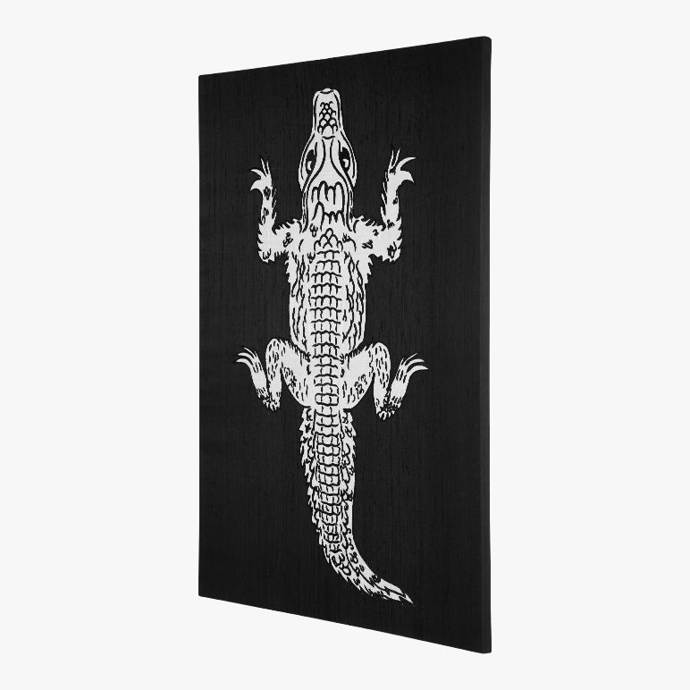 Black canvas with a white alligator design on a white background