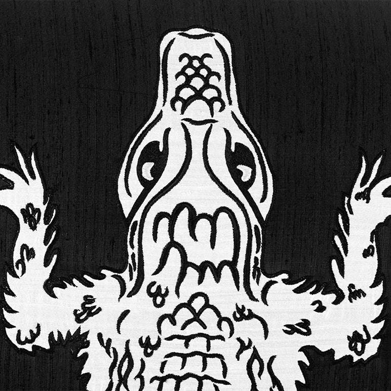 Black and white illustration of a stylized creature with a prominent head and body on a dark background.