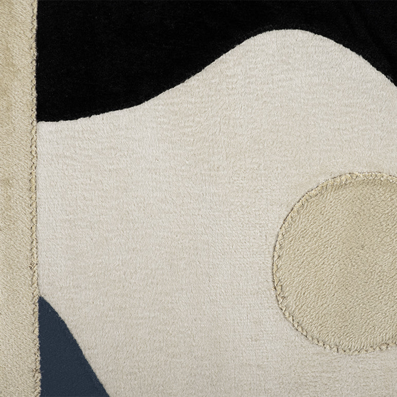 Close-up of a textured fabric with geometric patterns in beige, black, and brown.