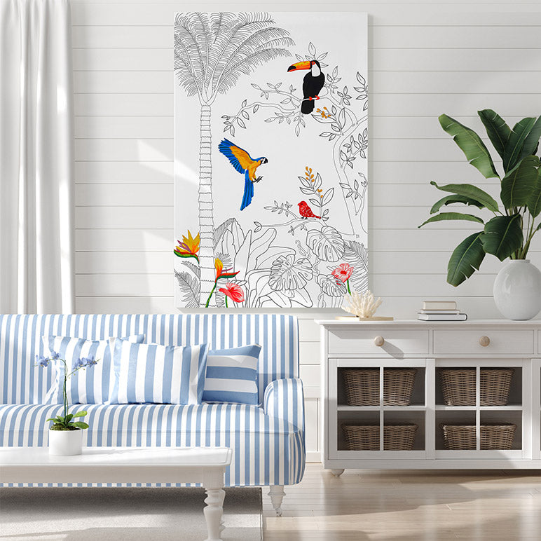 Living room with a blue and white striped sofa, decorative wall art of birds and plants, and a white cabinet.