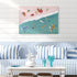 Living room with a blue and white striped sofa, coffee table, and beach-themed wall art.