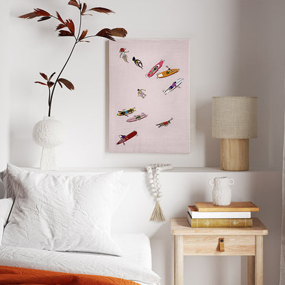Room interior with a bed, nightstand, lamp, and a pink beach themed wall art.
