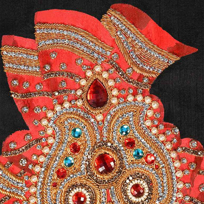 Decorative red and gold hand with gemstones on a black background