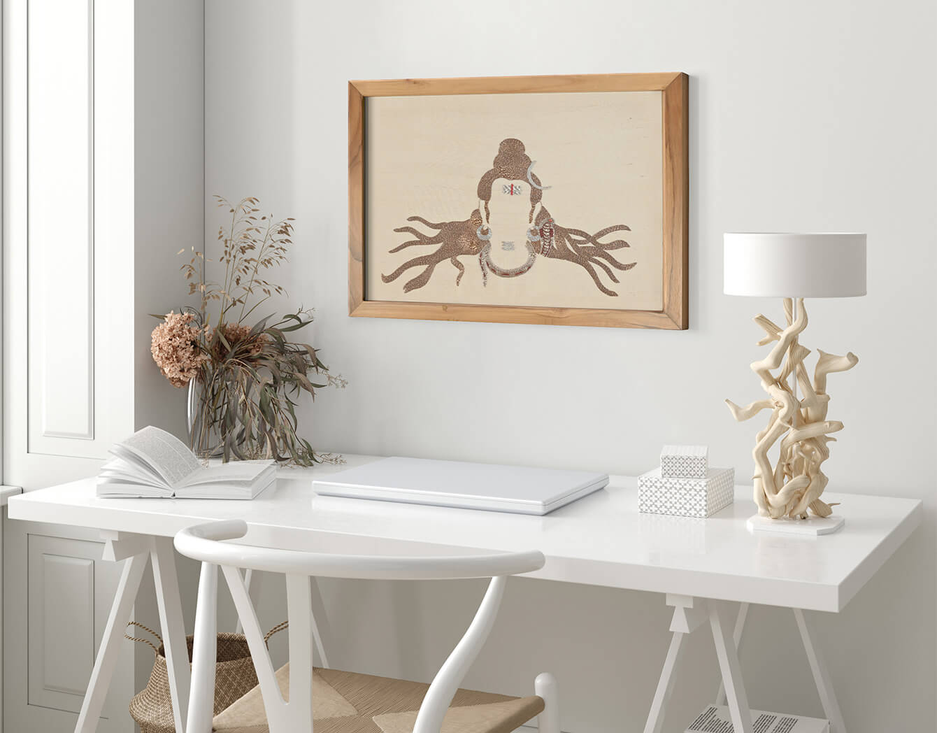 White desk with a laptop, lamp, and decorative items in a home office setting.