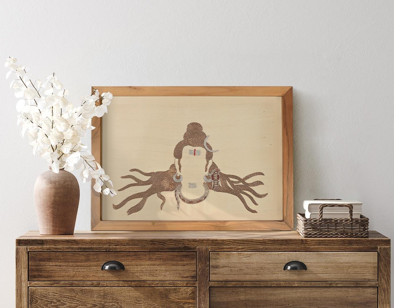 Framed artwork of a monkey and octopus on a wooden dresser with decorative items.