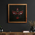 Framed artwork of a stylized face with red accents on a dark wall.