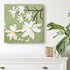 Floral painting on a wall above a white cabinet with decorative items.
