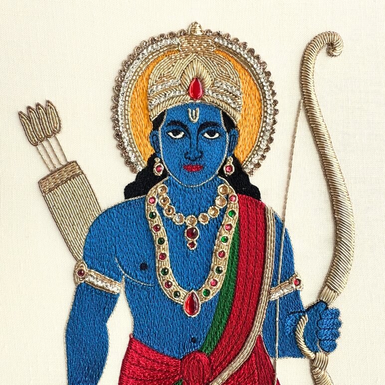 Close-up of gold zardozi embroidery and silk thread painting details on Lord Rama artwork