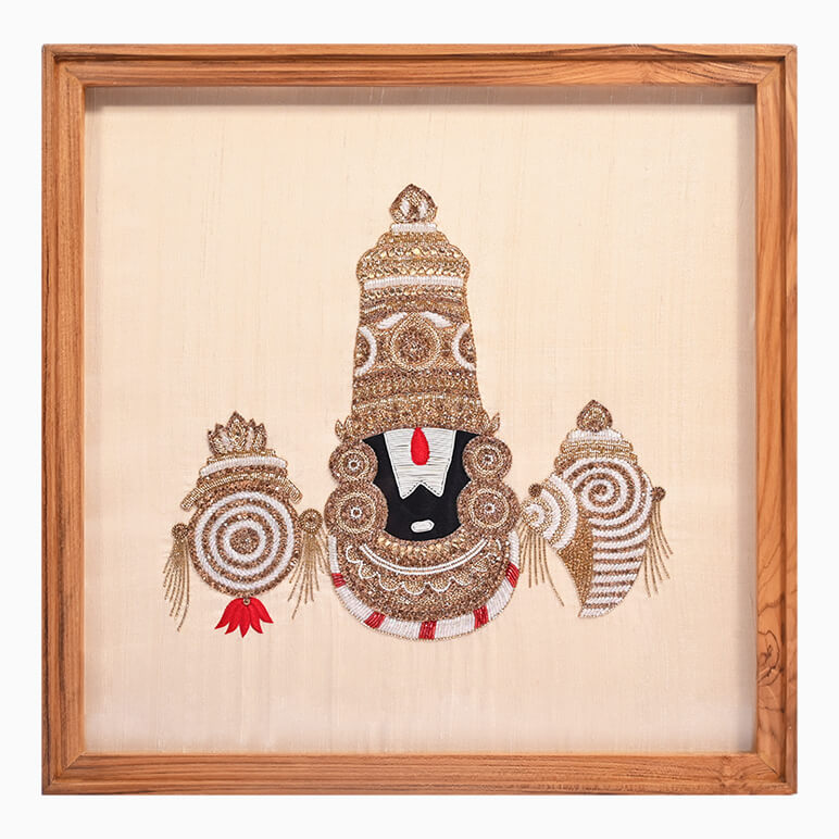 Decorative headpiece with intricate designs on a beige background, framed in wood.