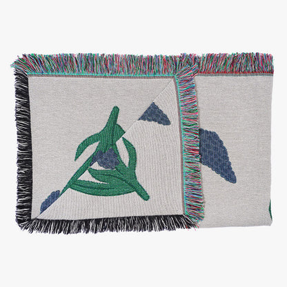 Throw blanket with woven design of blue Muscari flowers with green stems