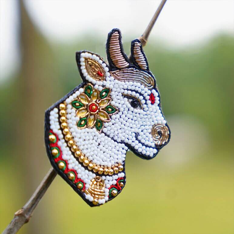 Decorative bull head with beadwork on a blurred natural background