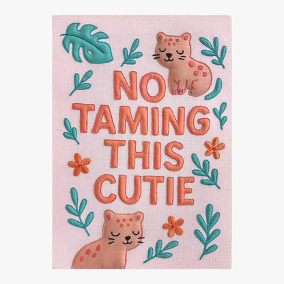Embroidered pink nursery room art with the words no taming this cutie on it