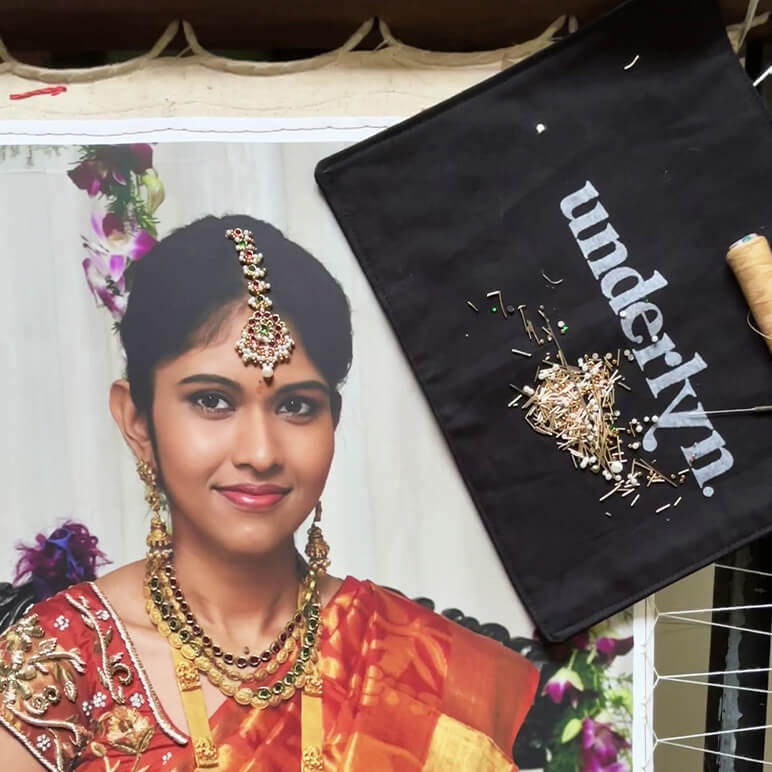 custom embroidered portrait of a woman in orange saree