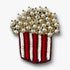 Pearl-topped popcorn bucket brooch pin with red-and-white sequined stripes on a white background