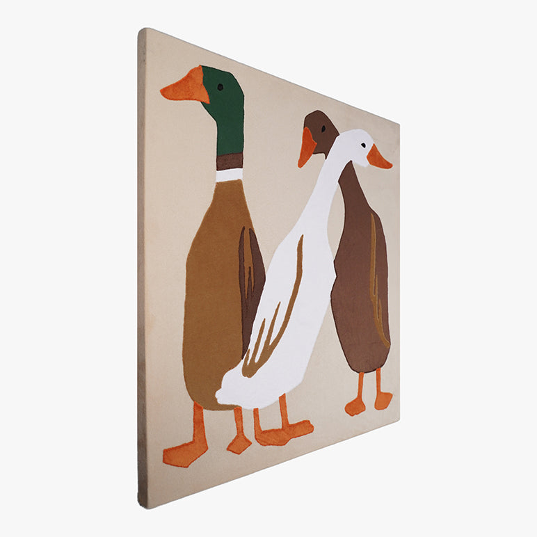 Wooden toy with three ducks on a beige background