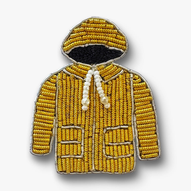 Gold hoodie brooch hand-embroidered on white background