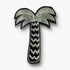 Silver palm tree brooch pin on a white background