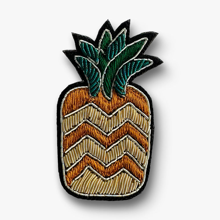 Green-leaf pineapple brooch pin with chevron pattern on a white background