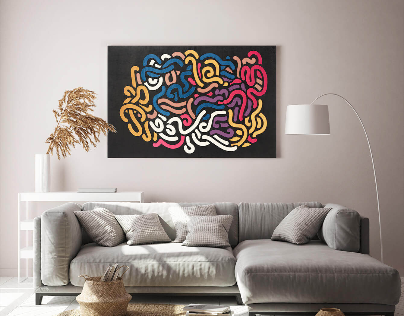 Colorful abstract wall art above a gray sofa in a living room.