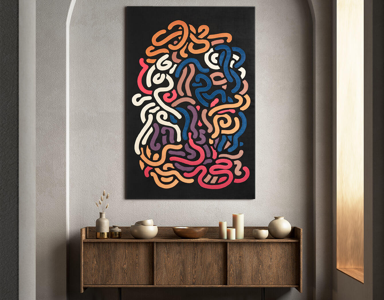 Colorful abstract art on a wall above a wooden console table.