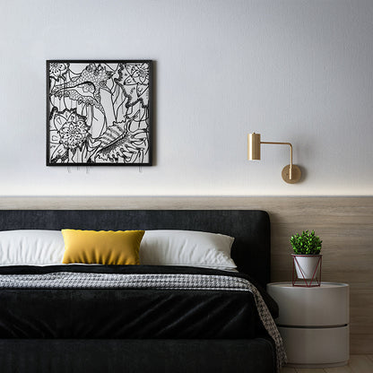 Modern bedroom with black floral wall art, yellow pillow, and white nightstand.