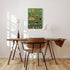 Wooden desk with chair and a colorful wall art piece in a room with wooden flooring.
