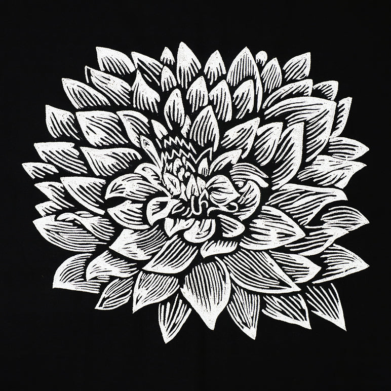 Textile artwork of an black and white floral design on a black background