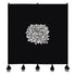 Black floral wall hanging with a white floral design and tassels on a white background