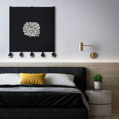 Modern bedroom with black headboard, yellow pillow and black Dahlia embroidered wall hanging