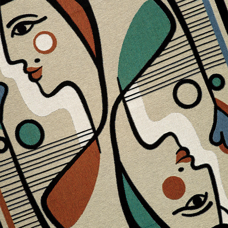 Abstract artwork with two playing card inspired faces on a designer throw blanket closeup