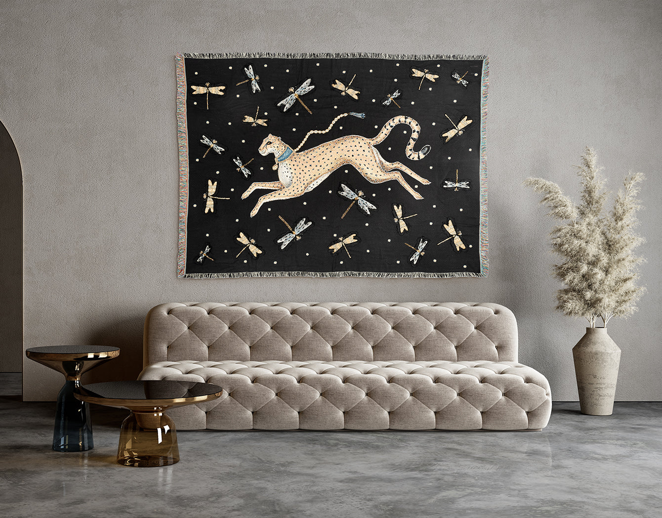 Decorative wall tapestry with a cheetah design above a beige sofa in a room.