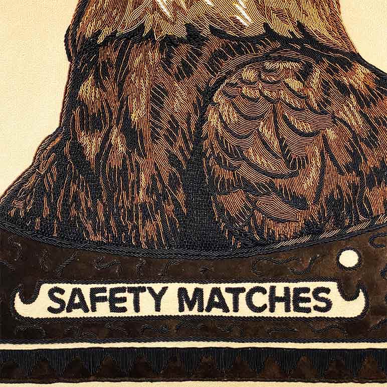 Vintage-style matchbox with intricate design and &