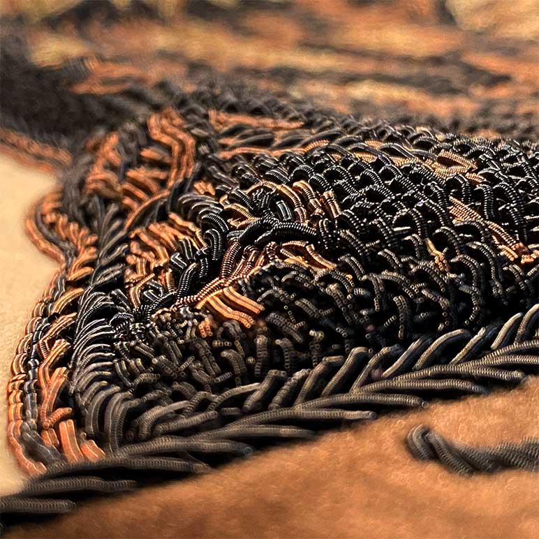 Close-up of intricate black and brown embroidery on fabric