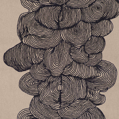 Close-up of an embroidered wall hanging with concentric circular patterns