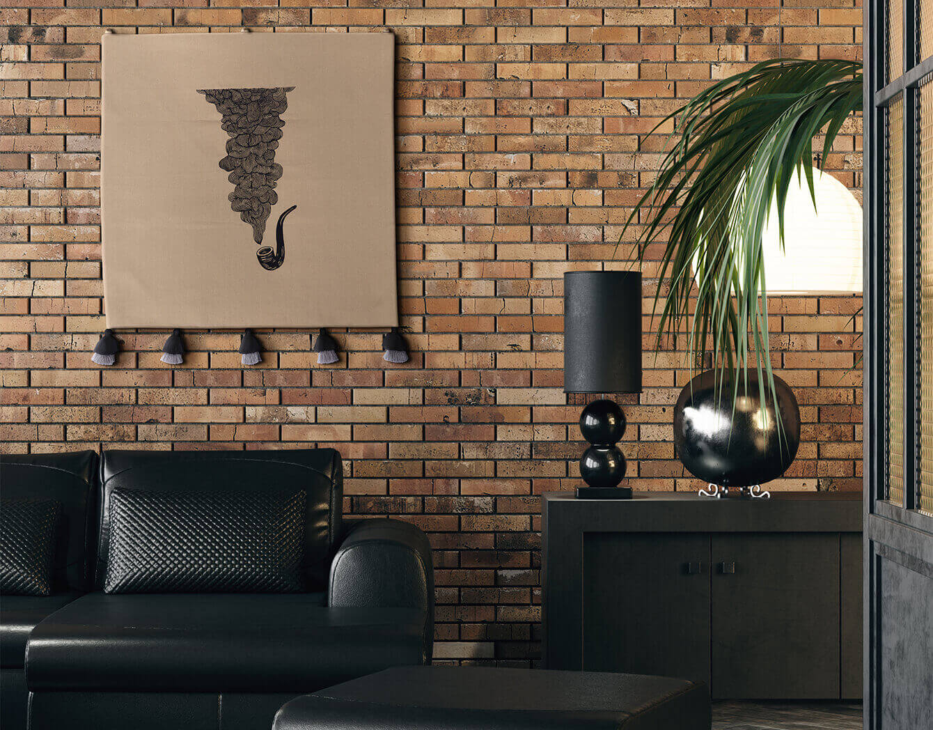 Modern living room with black sofa, decorative wall hanging, and brick wall.