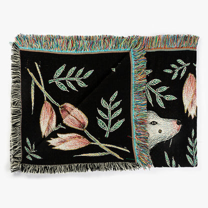 Decorative throw blanket with floral and animal patterns on a white background
