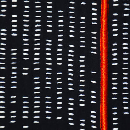 Close-up of a fabric with white vertical stitching lines on a black background and a red stripe.