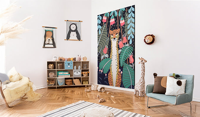 Children's room with a large tapestry of animals and plants, bookshelf, and furniture.