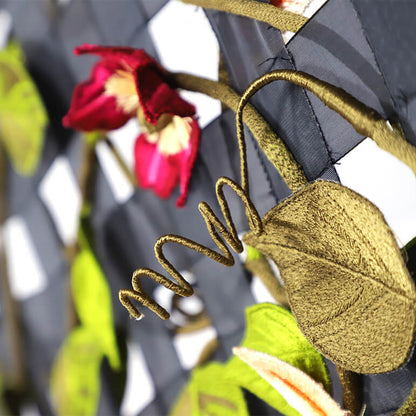 Close-up of a decorative fabric with floral patterns and embroidered text.