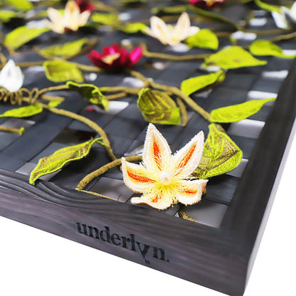 Decorative flower and leaf design on a black surface with &