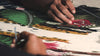 video showcasing the making of a colorful hand embroidered textile wall art with a cheetah in a jungle