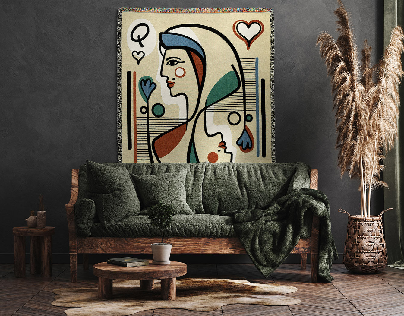 Living room with a green sofa, wooden coffee table, and an abstract throw blanket hung up on the wall