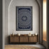 Decorative wall tapestry with geometric pattern on a neutral wall above a wooden console table.