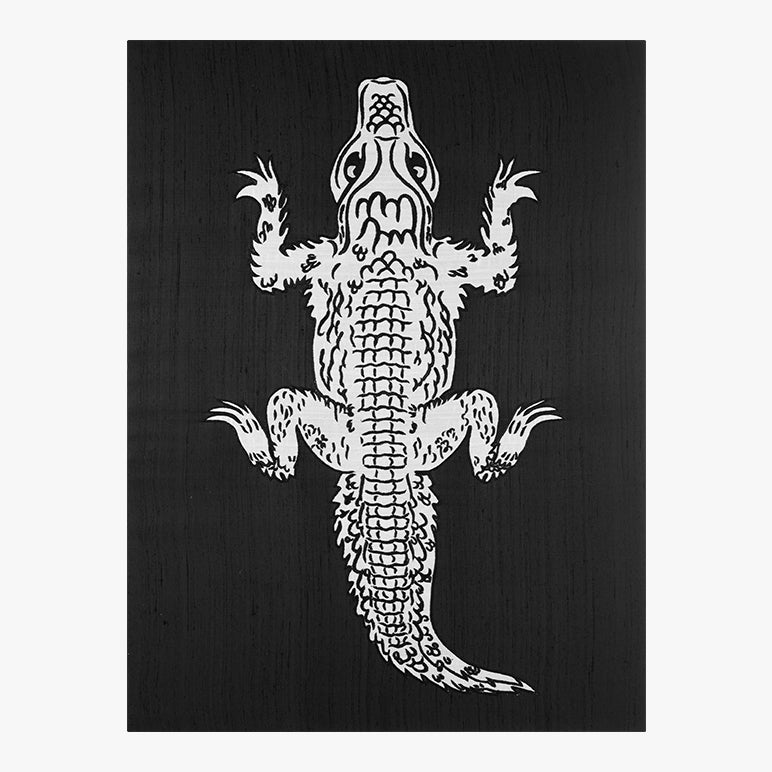White silhouette of an alligator on a black background