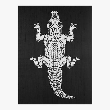 White silhouette of an alligator on a black background