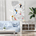 Living room with a blue and white striped sofa, decorative wall art of birds and plants, and a white cabinet.