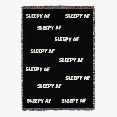 couch throw blanket in black with the phrase sleepy AF woven in white