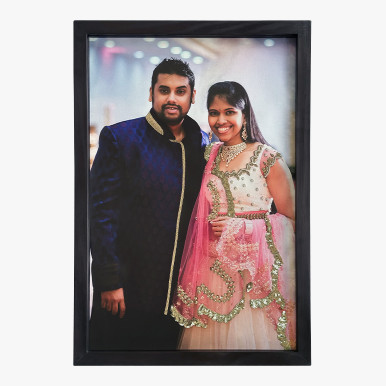 unique anniversary gift showcasing a couple in festive attire, framed in black